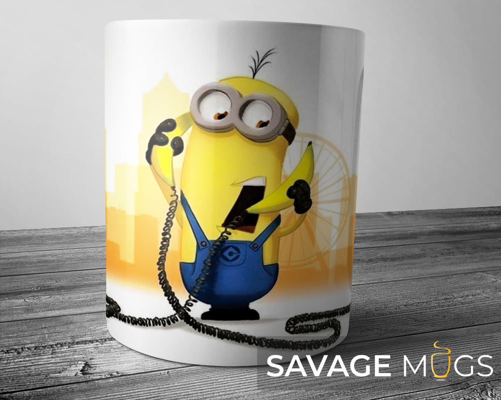 White ceramic mug with banana cartoon inspired character holding a telephone