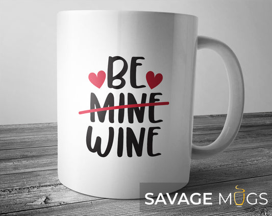 White ceramic mug with Be Mine Wine text design and hearts