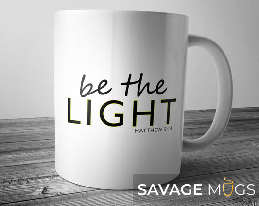 White ceramic mug featuring inspirational Christian message Be The Light Matthew 5:14