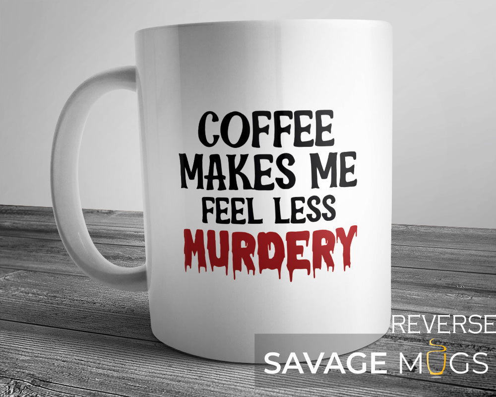 White ceramic mug with the phrase Coffee Makes Me Feel Less Murdery in bold black and red text