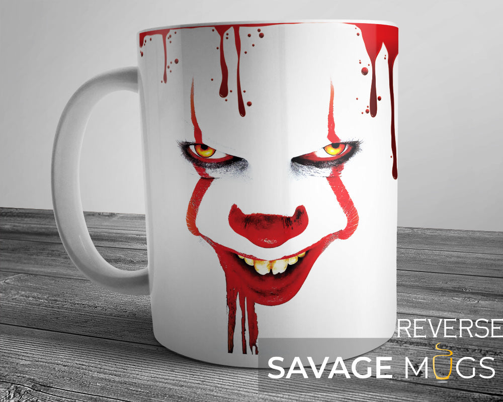 White ceramic mug featuring creepy clown inspired horror design with red paint streaks
