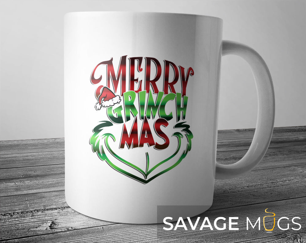 White ceramic mug featuring Merry Grinchmas Christmas design with festive red and green lettering