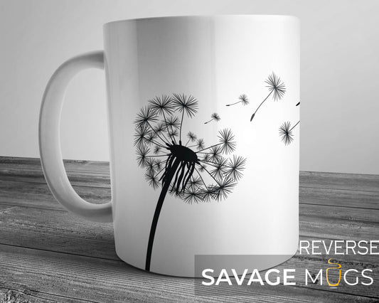 White ceramic mug with minimalist dandelion design and drifting seeds