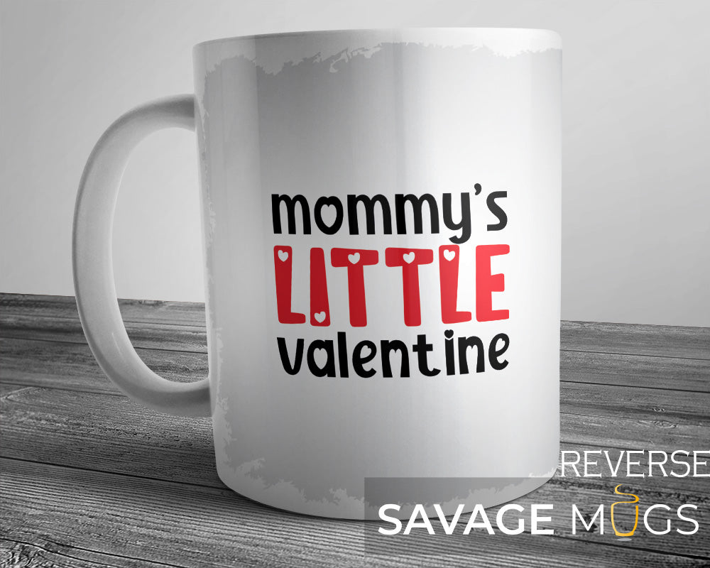 White ceramic mug with Mommy’s Little Valentine text and heart design
