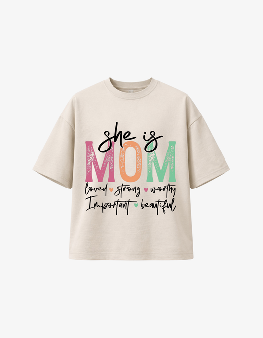 Beige 300 GSM boxy fit cotton t-shirt with “She Is Mom” inspirational quote design in soft pastel colours