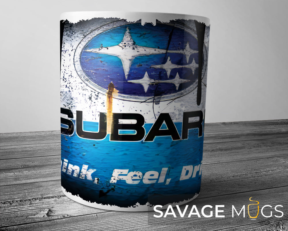 White ceramic mug featuring Subaru logo with vintage rally style grunge design
