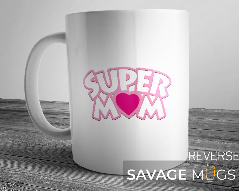 White ceramic mug with pink Super Mom text and heart design