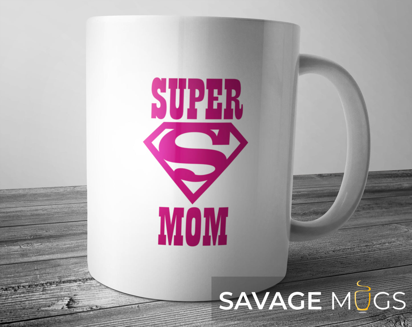 White ceramic mug with pink Super Mom superhero emblem design