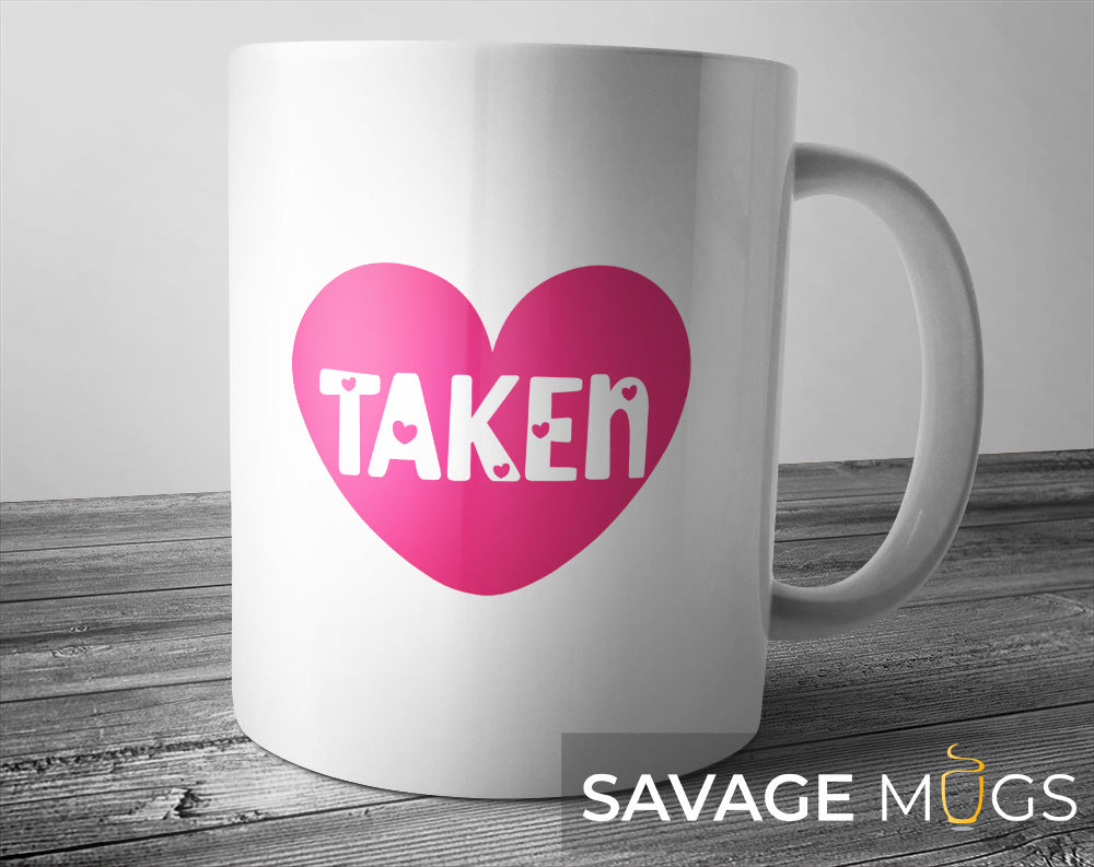 White ceramic mug with pink heart and Taken relationship design
