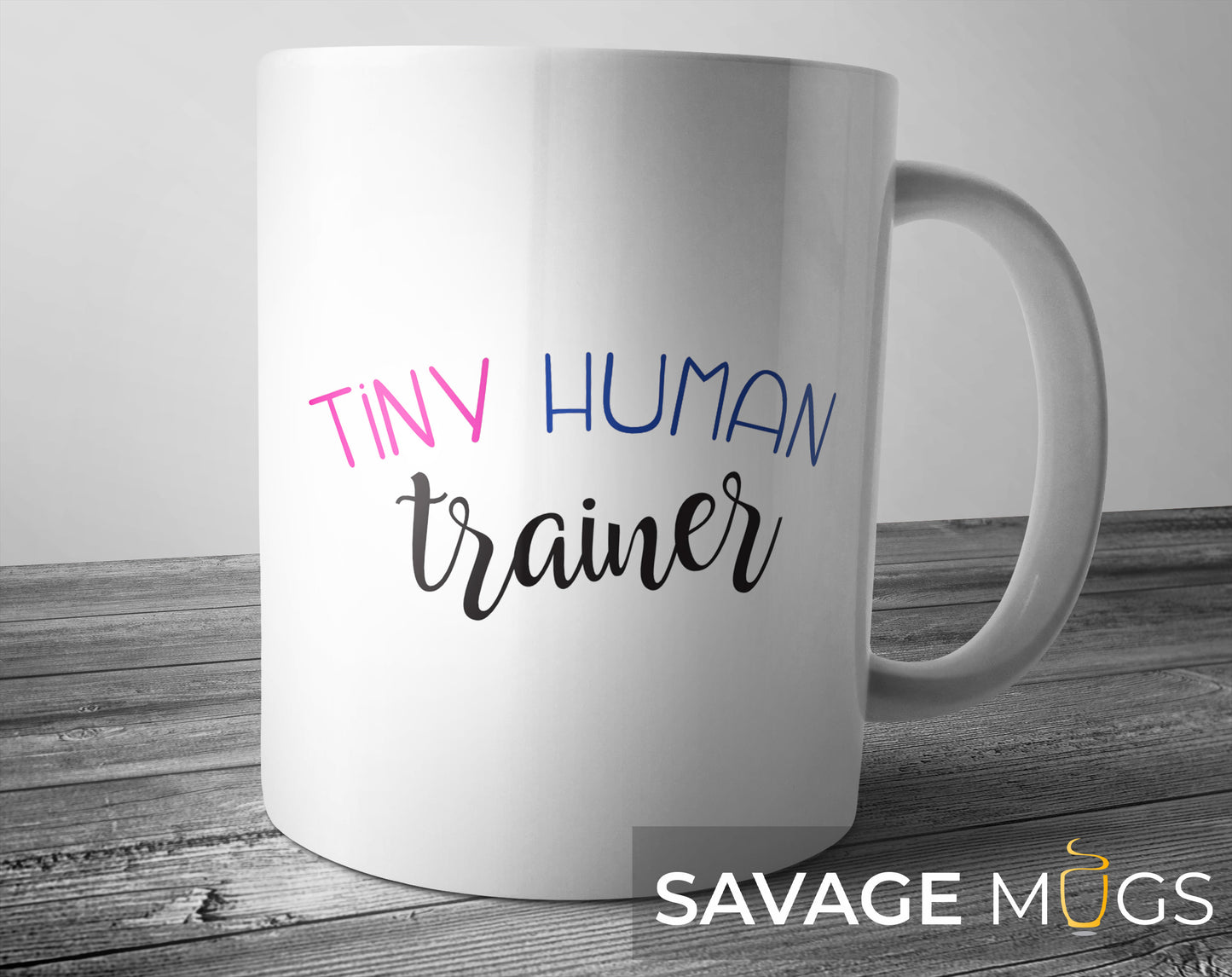 White ceramic mug with Tiny Human Trainer text design for moms