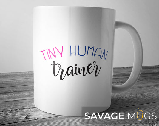 White ceramic mug with Tiny Human Trainer text design for moms