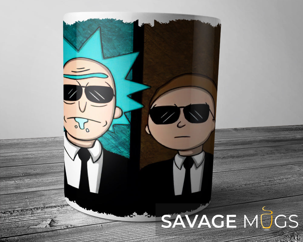 White ceramic mug featuring Rick and Morty dressed as secret agents in black suits and sunglasses