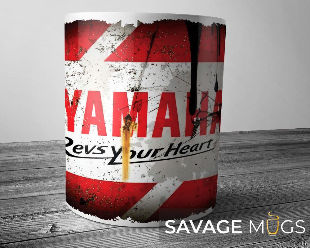 White ceramic mug featuring Yamaha logo with distressed racing motorcycle design