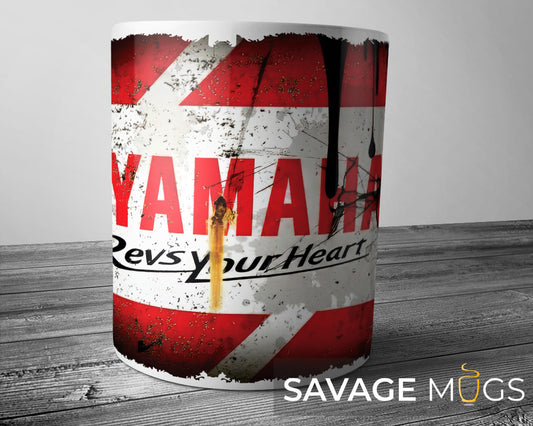 White ceramic mug featuring Yamaha logo with distressed racing motorcycle design